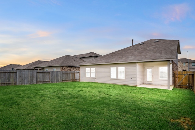 5122 Moonlit Garden Ln, Katy, TX 77449 - back of property with a fenced backyard, a patio area, and roof with shingles