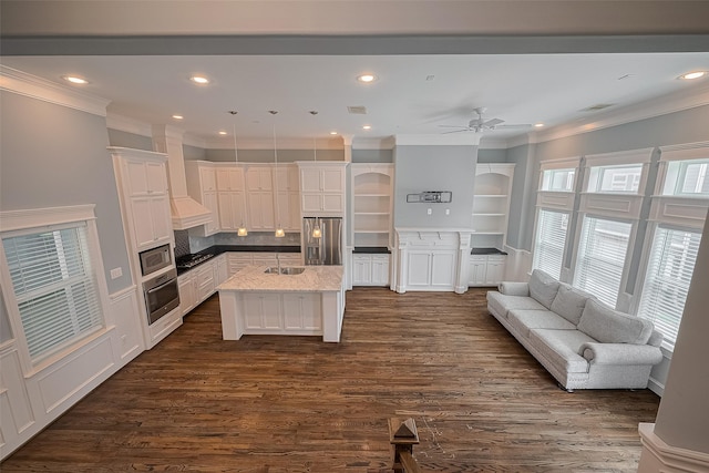 2106 Bidwell Dr, Houston, TX 77018 - kitchen featuring stainless steel appliances, ornamental molding, a kitchen island, open floor plan, and white cabinets