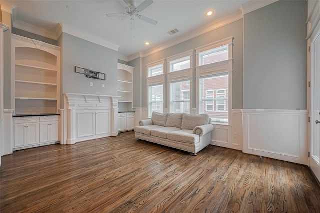 2106 Bidwell Dr, Houston, TX 77018 - living area featuring dark wood finished floors, ornamental molding, a ceiling fan, built in features, and wainscoting