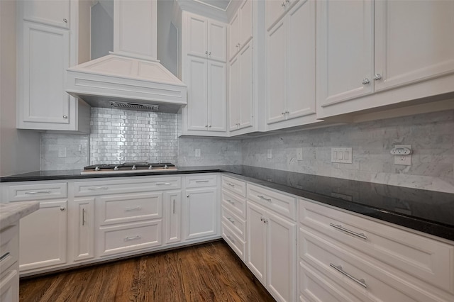 2106 Bidwell Dr, Houston, TX 77018 - kitchen with custom range hood, stainless steel gas stovetop, white cabinets, and dark countertops