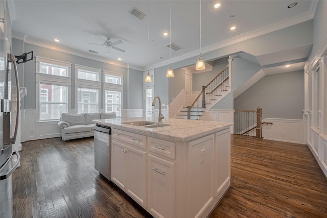 2106 Bidwell Dr, Houston, TX 77018 - kitchen featuring stainless steel appliances, a wainscoted wall, a ceiling fan, crown molding, and a decorative wall
