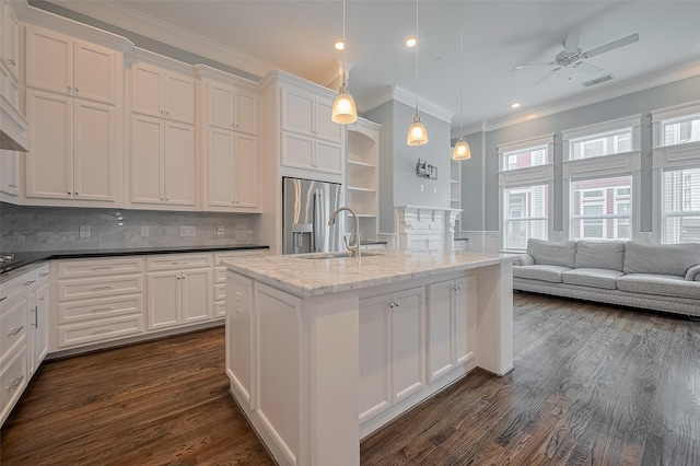 2106 Bidwell Dr, Houston, TX 77018 - kitchen with crown molding, stainless steel fridge with ice dispenser, ceiling fan, white cabinets, and a center island with sink