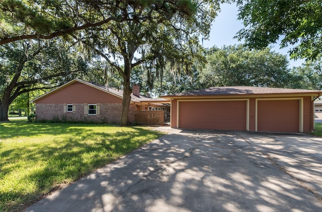 2004 Sleepy Hollow Dr, Pearland, TX 77581 - view of front of home with brick siding, concrete driveway, a front yard, a chimney, and an outdoor structure