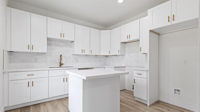 1719 Esther St B, Unit A, Houston, TX 77088 - kitchen featuring light wood-style floors, a center island, decorative backsplash, white cabinets, and recessed lighting