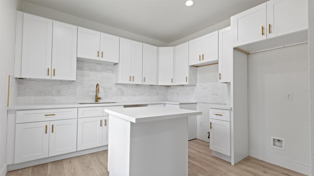 1719 Esther St B, Unit A, Houston, TX 77088 - kitchen with light wood finished floors, a center island, backsplash, white cabinetry, and recessed lighting
