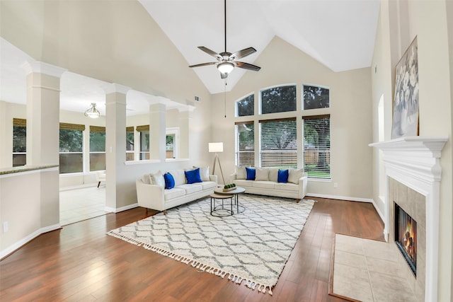 17422 Sunset Arbor Dr, Tomball, TX 77377 - living area with hardwood / wood-style floors, a ceiling fan, a tile fireplace, decorative columns, and high vaulted ceiling