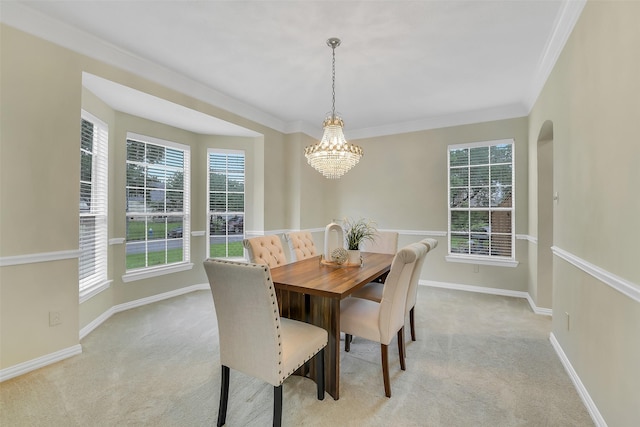 17422 Sunset Arbor Dr, Tomball, TX 77377 - dining room with a chandelier, light carpet, ornamental molding, and arched walkways