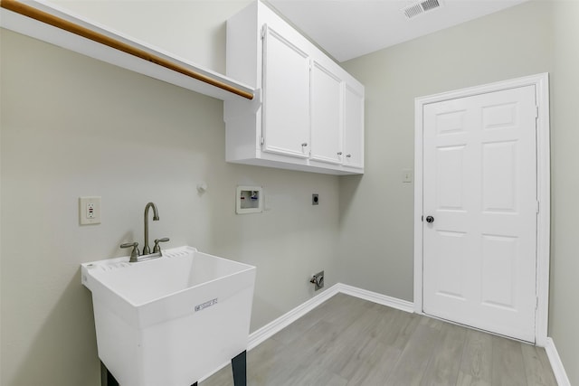 17422 Sunset Arbor Dr, Tomball, TX 77377 - laundry area featuring hookup for a washing machine, electric dryer hookup, cabinet space, and light wood-style flooring