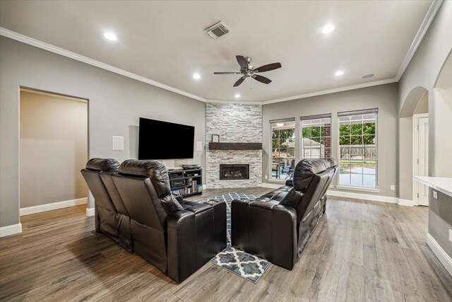 1611 Barrington Hills Ln, Katy, TX 77450 - living area featuring ceiling fan, light wood finished floors, recessed lighting, arched walkways, and a fireplace