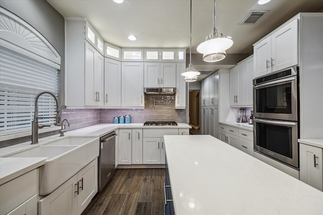 1611 Barrington Hills Ln, Katy, TX 77450 - kitchen with stainless steel appliances, white cabinets, tasteful backsplash, and recessed lighting