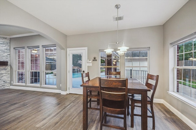 1611 Barrington Hills Ln, Katy, TX 77450 - dining room with wood finished floors, arched walkways, and a chandelier
