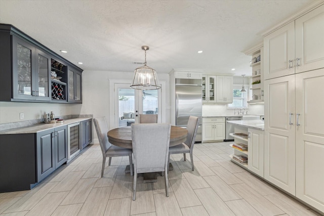 2603 Haverhill Dr, Houston, TX 77008 - dining area with beverage cooler, healthy amount of natural light, bar, and recessed lighting