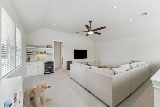 2603 Haverhill Dr, Houston, TX 77008 - living room with lofted ceiling, bar with sink, wine cooler, light carpet, and ceiling fan