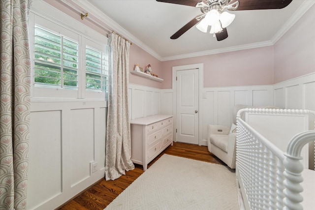 2603 Haverhill Dr, Houston, TX 77008 - bedroom featuring a wainscoted wall, crown molding, dark wood-style flooring, a decorative wall, and ceiling fan