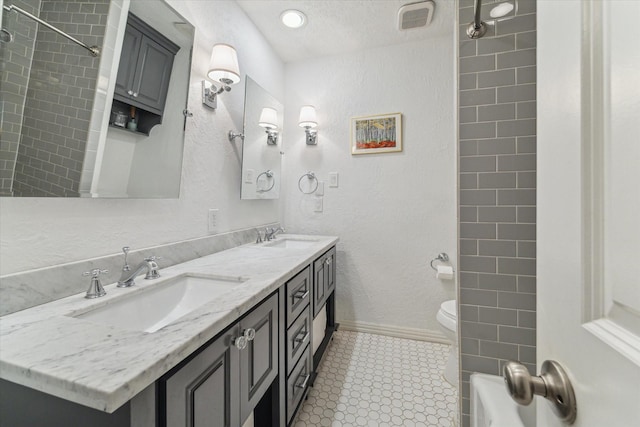 2603 Haverhill Dr, Houston, TX 77008 - full bathroom with double vanity and a textured wall