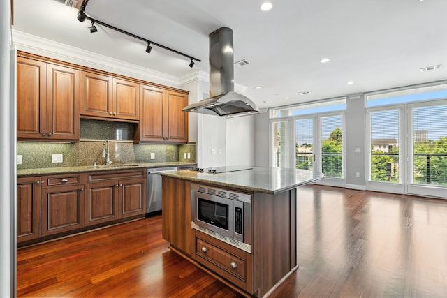 1419 Montrose Blvd Unit 301, Houston, TX 77019 - kitchen with appliances with stainless steel finishes, island range hood, track lighting, stone countertops, and dark wood-style flooring