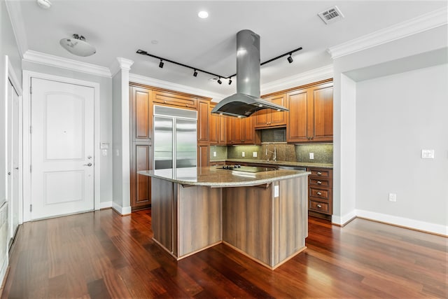 1419 Montrose Blvd Unit 301, Houston, TX 77019 - kitchen with stainless steel built in refrigerator, island exhaust hood, dark wood-style floors, light stone counters, and crown molding