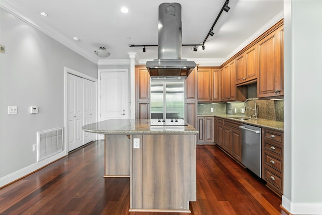 1419 Montrose Blvd Unit 301, Houston, TX 77019 - kitchen with stainless steel appliances, island exhaust hood, light stone countertops, a center island, and ornamental molding