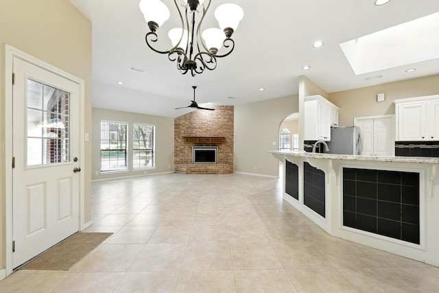 24806 Silver Leaf St, Magnolia, TX 77355 - unfurnished living room with ceiling fan, light tile patterned floors, a chandelier, a brick fireplace, and recessed lighting