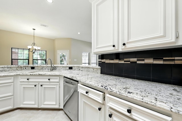 24806 Silver Leaf St, Magnolia, TX 77355 - kitchen with stainless steel dishwasher, a chandelier, backsplash, light stone counters, and recessed lighting