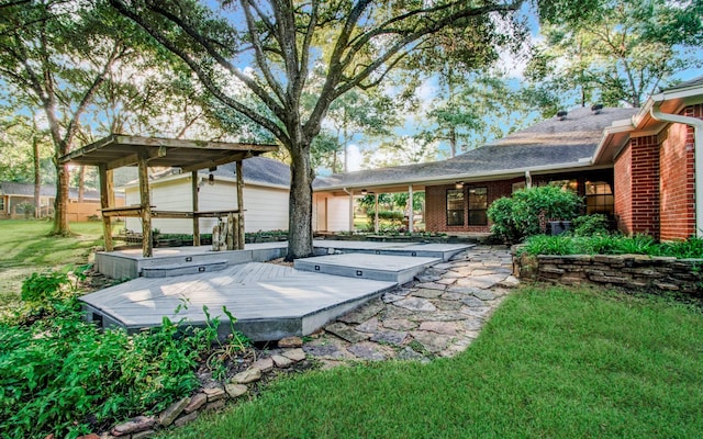 24806 Silver Leaf St, Magnolia, TX 77355 - back of property with a wooden deck, a lawn, brick siding, a hot tub, and roof with shingles