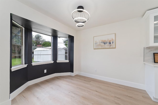 13019 Foxburo Dr, Houston, TX 77065 - unfurnished dining area featuring light wood finished floors and a chandelier