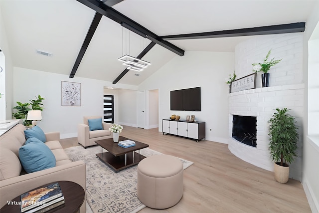 13019 Foxburo Dr, Houston, TX 77065 - living room featuring beam ceiling, light wood-style flooring, a fireplace, and high vaulted ceiling