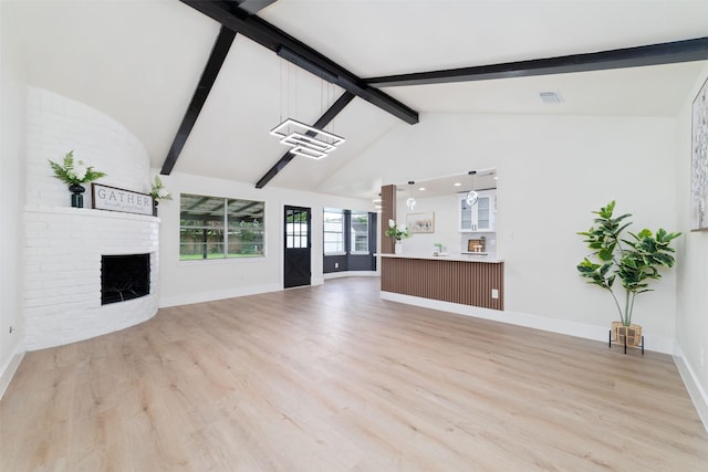 13019 Foxburo Dr, Houston, TX 77065 - unfurnished living room with beamed ceiling, light wood-style flooring, a fireplace, and high vaulted ceiling