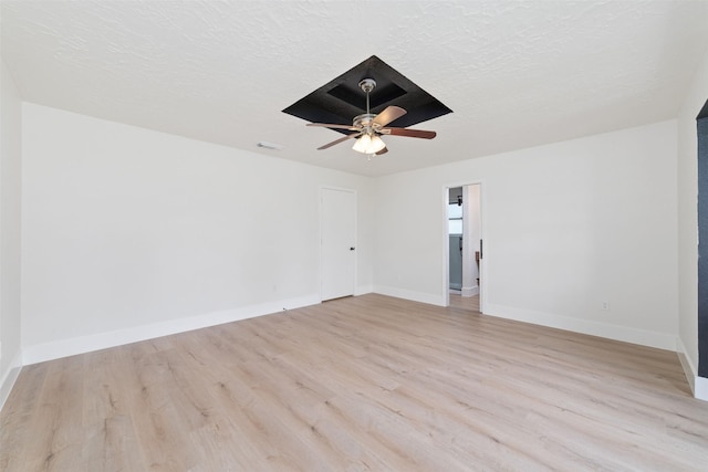 13019 Foxburo Dr, Houston, TX 77065 - spare room with light wood-type flooring, a ceiling fan, and a textured ceiling