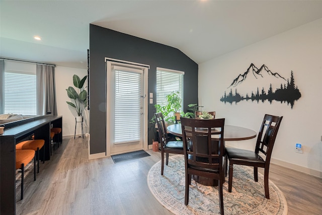 7822 Murciana Dr, Rosharon, TX 77583 - dining space with light wood finished floors, vaulted ceiling, and recessed lighting