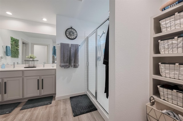 7822 Murciana Dr, Rosharon, TX 77583 - bathroom with double vanity, a shower stall, wood finished floors, and recessed lighting