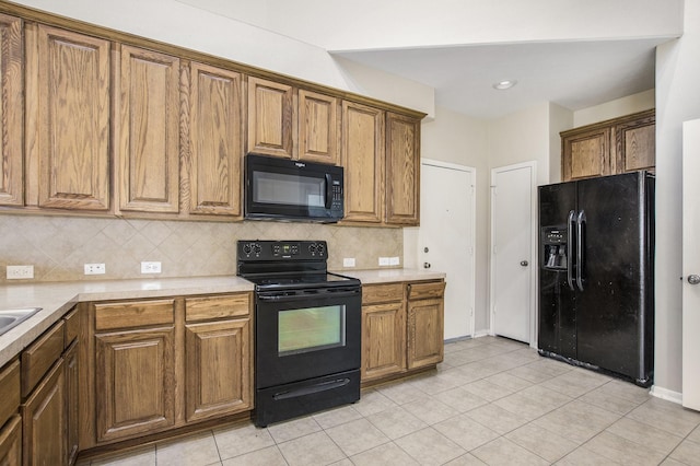 20515 Rustic Rail Ct, Cypress, TX 77433 - kitchen with black appliances, brown cabinets, tasteful backsplash, and light countertops
