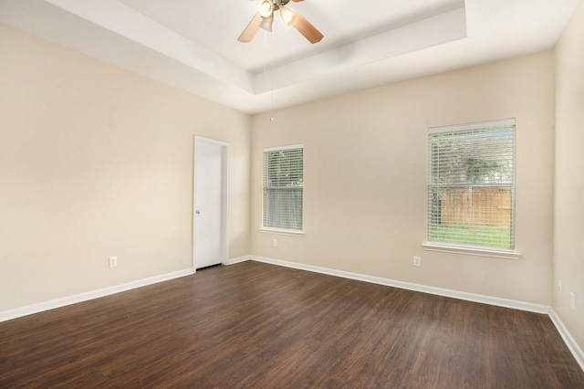 20515 Rustic Rail Ct, Cypress, TX 77433 - unfurnished room with dark wood-style flooring, a tray ceiling, and a ceiling fan
