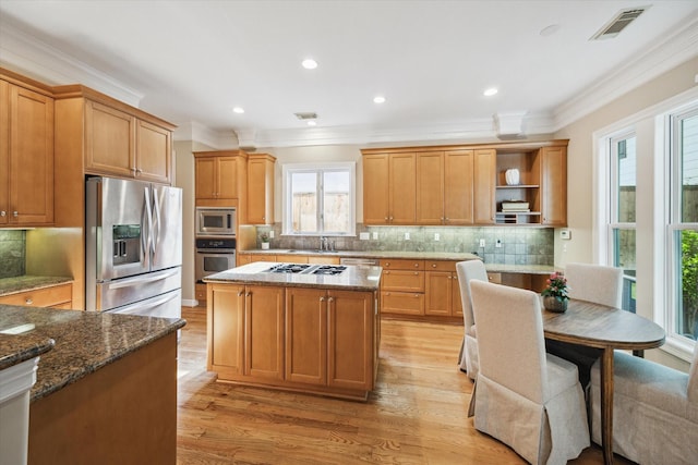 3614 University Blvd, West University Place, TX 77005 - kitchen featuring stainless steel appliances, crown molding, open shelves, light wood-style floors, and backsplash