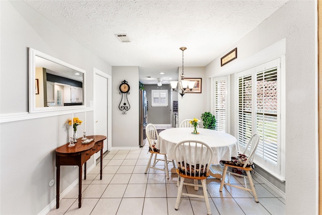 3426 Acorn Springs Ln, Spring, TX 77389 - dining space with a textured ceiling, a chandelier, and light tile patterned floors
