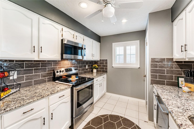 3426 Acorn Springs Ln, Spring, TX 77389 - kitchen with appliances with stainless steel finishes, tasteful backsplash, ceiling fan, white cabinets, and recessed lighting