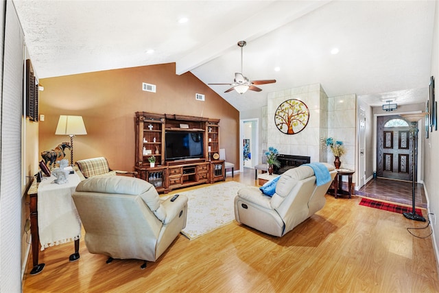 3426 Acorn Springs Ln, Spring, TX 77389 - living area featuring wood finished floors, a ceiling fan, and a tiled fireplace