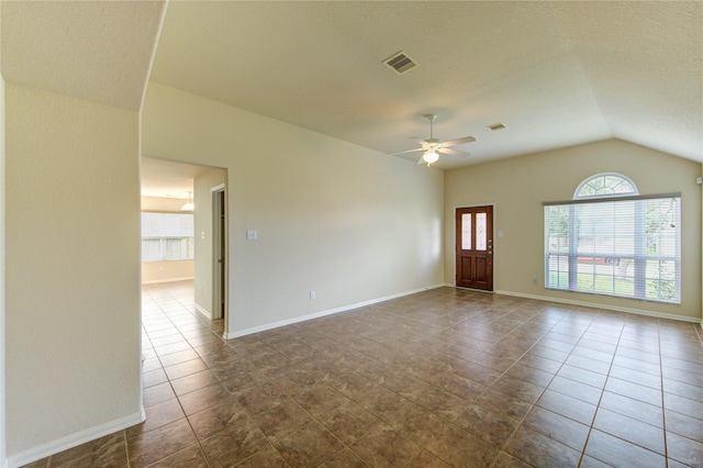 14839 Fir Knoll Way, Cypress, TX 77429 - spare room featuring plenty of natural light, dark tile patterned flooring, lofted ceiling, and ceiling fan