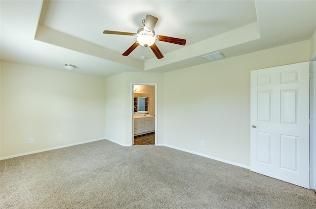 14839 Fir Knoll Way, Cypress, TX 77429 - unfurnished bedroom featuring a raised ceiling, carpet, connected bathroom, and ceiling fan