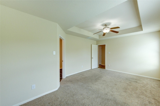 14839 Fir Knoll Way, Cypress, TX 77429 - empty room featuring a tray ceiling, carpet floors, and ceiling fan