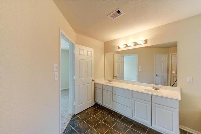 14839 Fir Knoll Way, Cypress, TX 77429 - bathroom featuring double vanity, a textured ceiling, and tile patterned floors