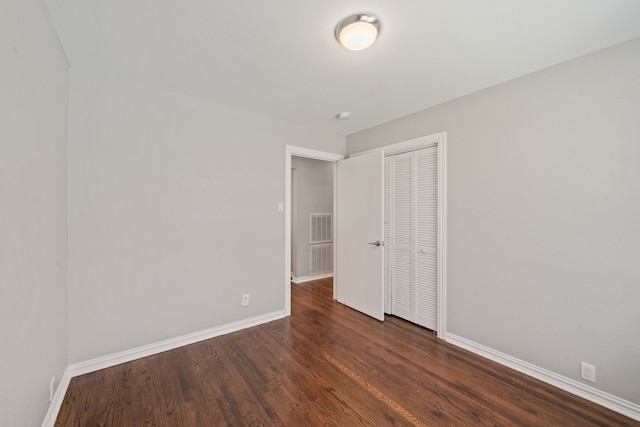 2111 Bron Holly Dr, Houston, TX 77018 - unfurnished bedroom featuring dark wood-style floors and a closet