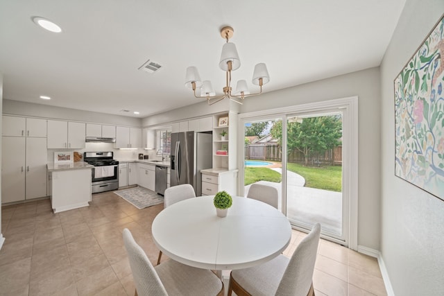 2111 Bron Holly Dr, Houston, TX 77018 - dining space featuring a chandelier, recessed lighting, and light tile patterned floors
