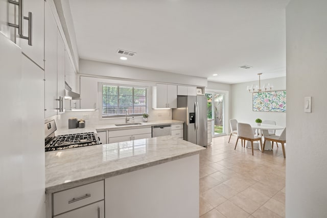2111 Bron Holly Dr, Houston, TX 77018 - kitchen featuring appliances with stainless steel finishes, decorative backsplash, recessed lighting, under cabinet range hood, and white cabinetry