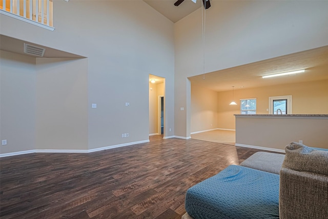 8134 Menorca Cove Dr, Cypress, TX 77433 - living area with dark wood-type flooring, a ceiling fan, and high vaulted ceiling