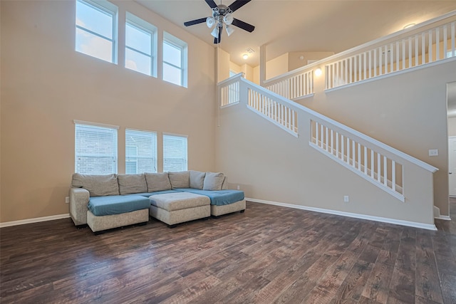 8134 Menorca Cove Dr, Cypress, TX 77433 - living area with wood finished floors, ceiling fan, a towering ceiling, and stairs