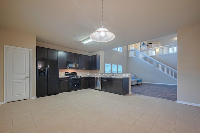 8134 Menorca Cove Dr, Cypress, TX 77433 - kitchen featuring black appliances, light countertops, plenty of natural light, and backsplash