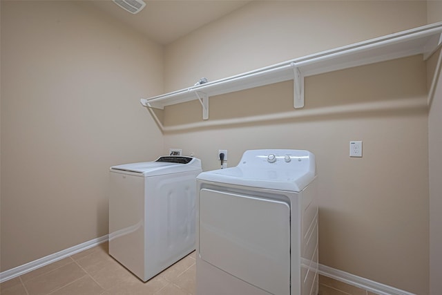 8134 Menorca Cove Dr, Cypress, TX 77433 - laundry area featuring washer and clothes dryer and light tile patterned flooring