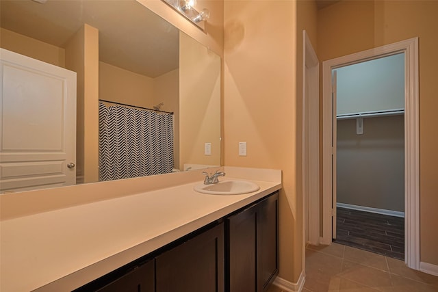 8134 Menorca Cove Dr, Cypress, TX 77433 - bathroom with vanity, tile patterned floors, a shower with shower curtain, and a walk in closet