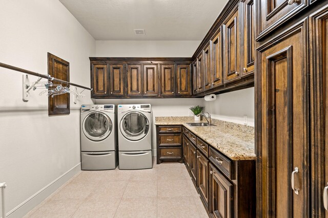 32723 Westminster Dr, Fulshear, TX 77441 - laundry area featuring cabinet space, washer and dryer, and light tile patterned floors